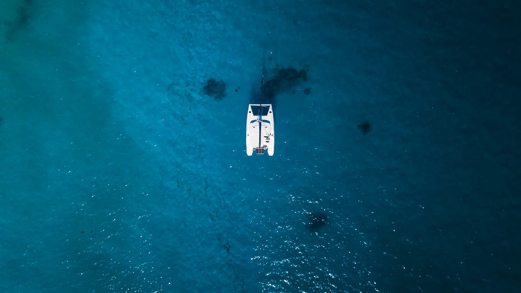 Catamaran at anchor, seen from above