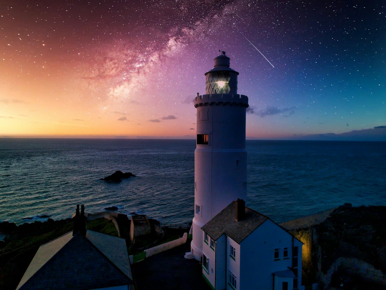 Lighthouse by the sea at night